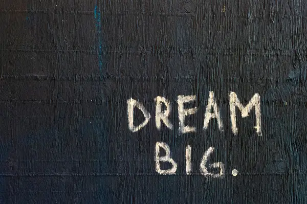The words "Dream Big" written on a chalkboard
